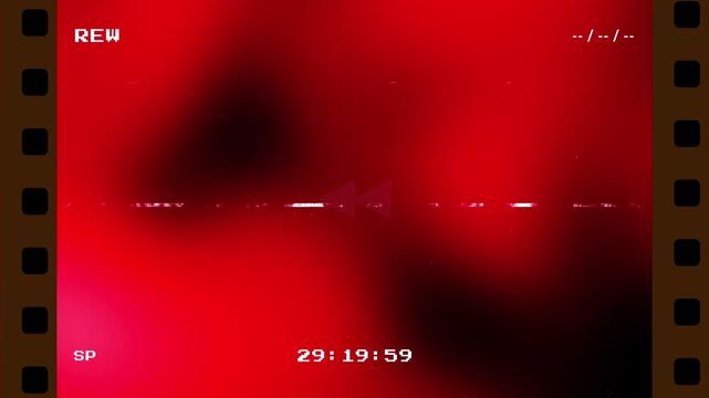 Retro VHS rewind transition with red light leaks and analog glitch effects featuring a film strip border and digital timecode on a black background for vintage video editing