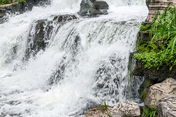 White waterfall cascading down rocky steps © Steve