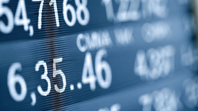 Close-up view of a digital stock market display screen showing fluctuating numerical data in white text against a blue background