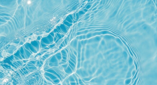 Abstract background of rippling blue water surface with sunlight reflections