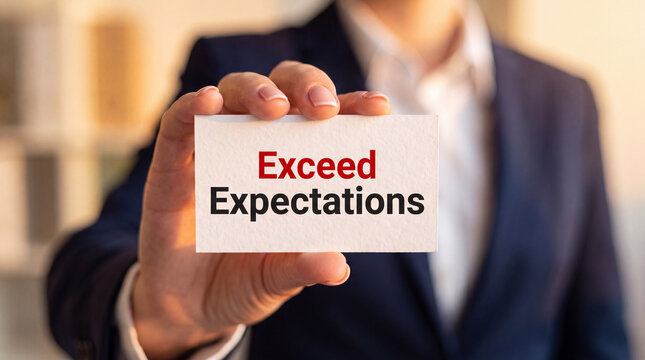 Business person holding Exceed Expectations sign. Professional showing corporate goal card.