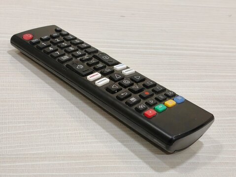 Modern black television remote control close up