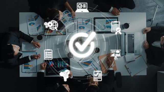Aerial view of a proactive business meeting with professionals collaborating around a table, utilizing digital tools and icons that symbolize efficiency and strategic planning. Raster