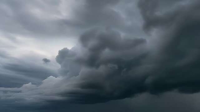 Dramatic dark storm clouds gathering in the sky creating an ominous and foreboding atmosphere before a heavy downpour