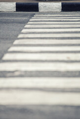 Obraz premium Abstract view of a pedestrian crossing with black and white stripes on asphalt
