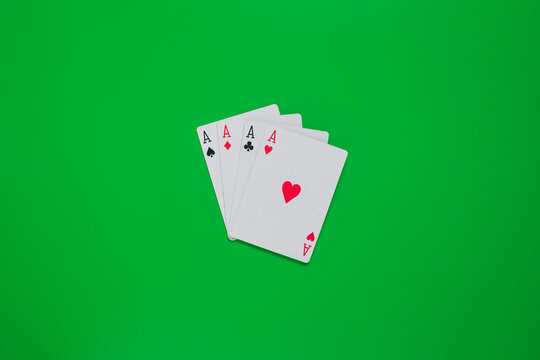 four aces playing cards on green casino table. gambling concept