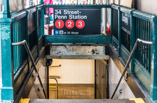 New York City, New York, USA, 14 June 2026: A close-up shot of a classic New York City Subway entrance staircase, with a sign for 34th Street Penn Station
