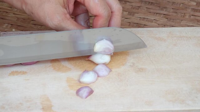 Slicing an Onion on a Wooden Cutting Board