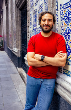 Man Leaning Against Tiled Wall Outdoors in Mexico City