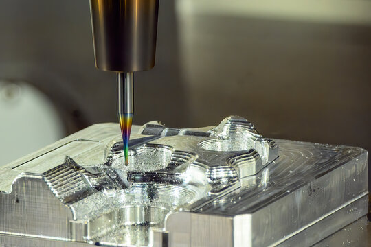 CNC milling machine performing mold finishing cut using special coated ball nose end mill tool
