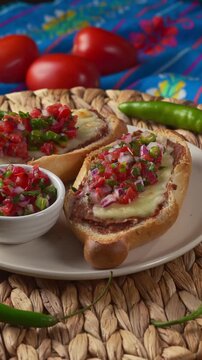 Traditional molletes ready to eat homemade mexican snacks on a white plate
