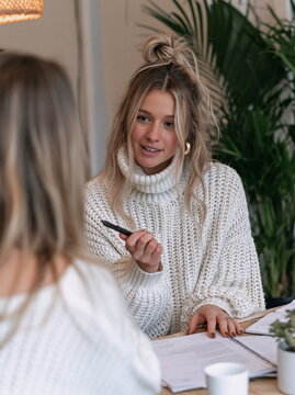 Compassionate Therapist Engaging with Client in Cozy Office Setting, Fostering Trust and Empathy Through Active Listening