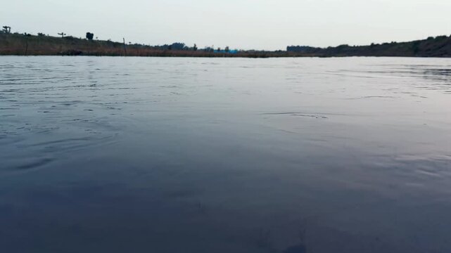 Calm River Water Flowing Gently Under Bright Daylight Natural Horizon