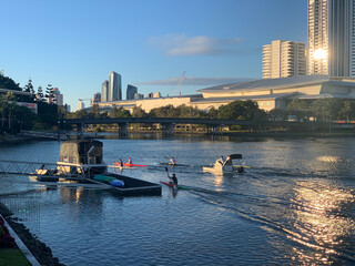 Kayakers and Rowers Training on Nerang River at Sunset © blueringmedia