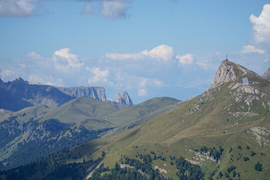 Rolling alpine meadows leading towards the Schlern Massif on a bright summer day in South Tyrol