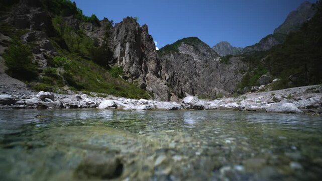 Water level view of fresh mountain river water flowing towards camera, Friulian Dolomites, Italy.