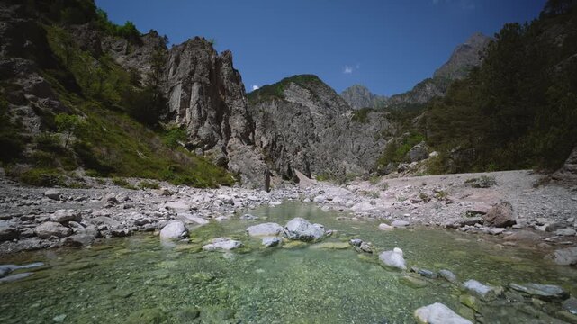 Mountain river stream water rushing over stones, Friulian Dolomites, Northern Italy. Low angle view