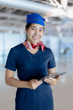 Airport ground service person, Asian beauty woman airline uniform standing happy smiling in airport