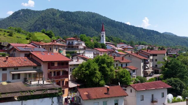 Aerial drone view of Most na Soci town in Slovenia, showing the settlement, surrounding hills and countryside landscape