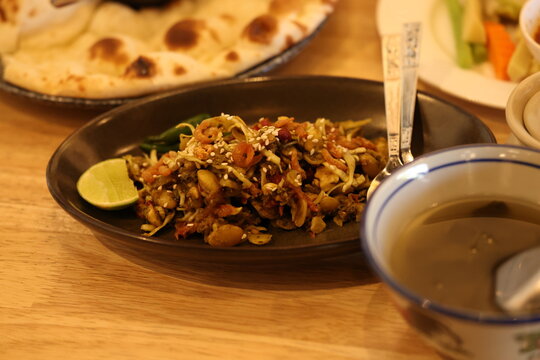 Traditional Burmese Tea Leaf Salad Served with Soup and Naan