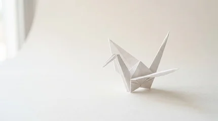 Fotobehang Kraanvogels Origami paper crane on plain surface  © Lily