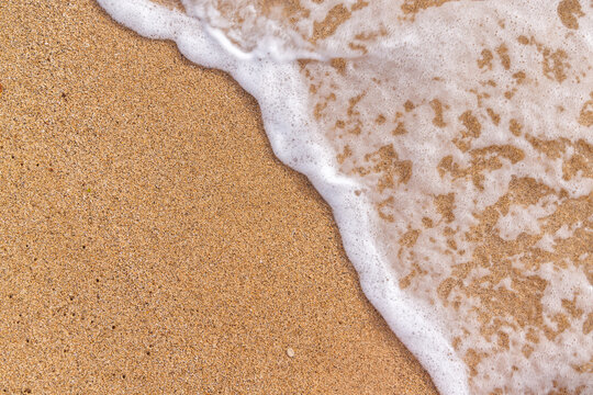 Sunny beach in Hawaii with golden sand, clear water under a bright sky