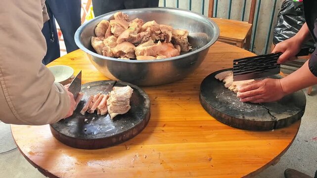 Village Festival Feast with Cooked Pork Being Sliced on Large Table