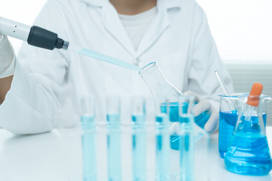 Scientist analyze biochemical samples in advanced scientific laboratory. Medical professional use dropper mix microbiological developmental of viral. Biotechnology research in  science lab. cosmetic