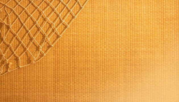 Woven rope fishing net casting shadows on woven bamboo mat