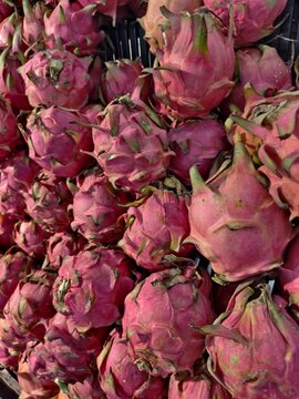 Group of ripe dragon fruit displayed at fruit stand with dragonfruit tropical superfood botanical