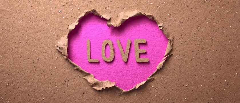 LOVE Text Revealed Through Heart-Shaped Torn Paper