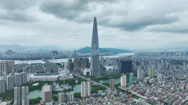 Aerial Drone View of Jamsil Station Cityscape, Lotte World Tower, and Han River Landscape in Seoul, South Korea