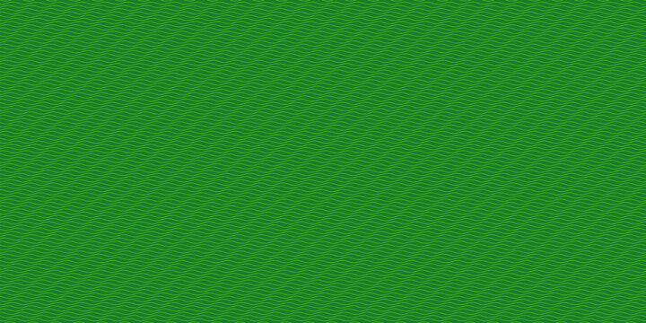 Close-up of bright green grass texture background. Vibrant lawn surface with fine blades for design and nature projects.