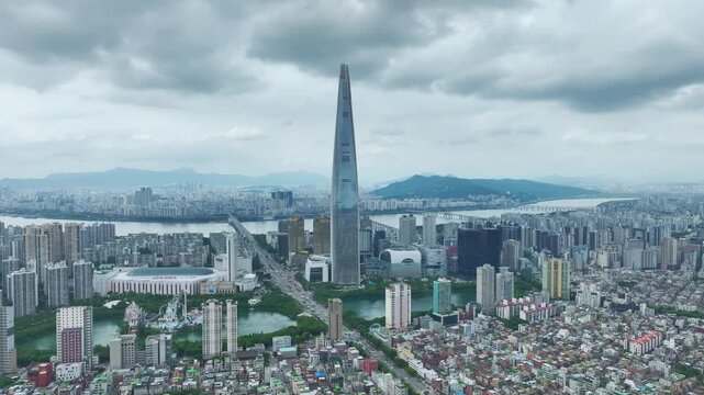 Aerial Drone View of Jamsil Station Cityscape, Lotte World Tower, and Han River Landscape in Seoul, South Korea