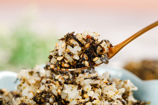 Instant Rice with Seaweed and Sesame Seeds on Wooden Spoon - Asian Snack Food Ready to Make