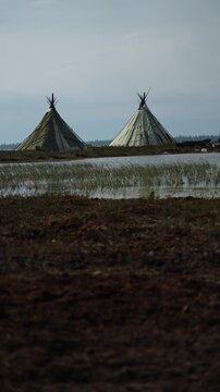 Conical Tents by a Marsh on Northern Tundra