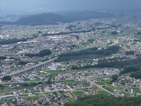 Village sprawls below, nestled among rolling hills