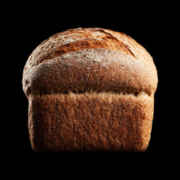 A rustic loaf of whole grain spelt bread on black background with clipping path, symbolizing bakery freshness and nourishment