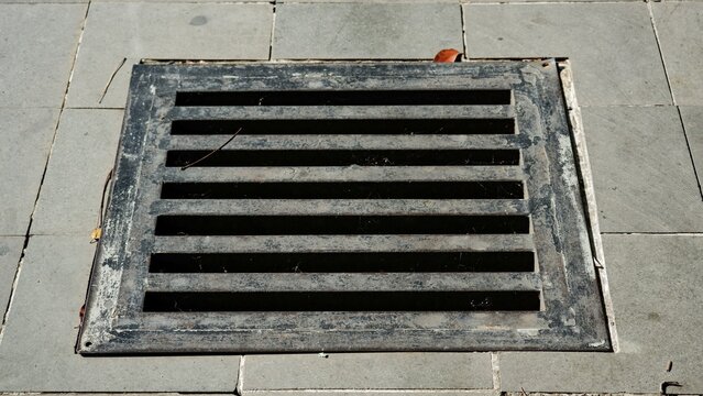 A heavy-duty metal storm drain cover designed to facilitate surface water runoff and prevent urban flooding.