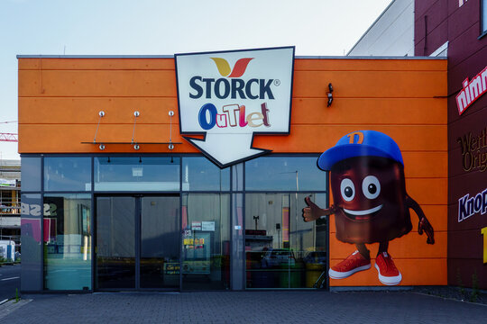 Mulheim-Karlich, Germany - July13, 2026: Storck Outlet building exterior showcasing various candy brand logos like Werther's Original and Knoppers,