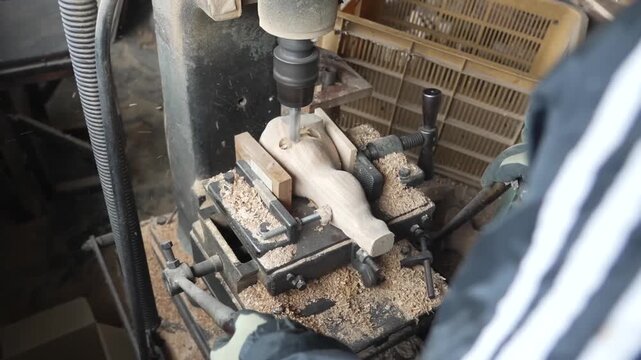 Craftsman using a bench drill press to hollow a wooden blank for a traditional Japanese carpenter ink line tool
