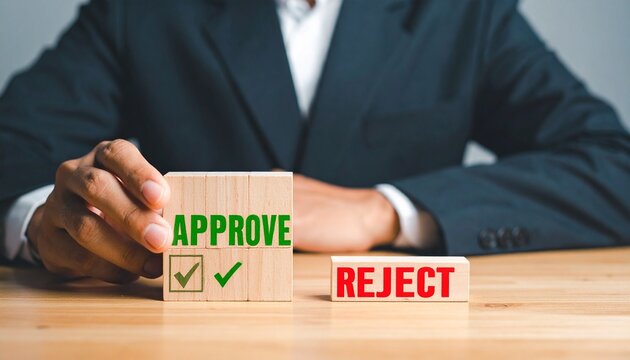 Businessman holding approve block beside reject option on table
