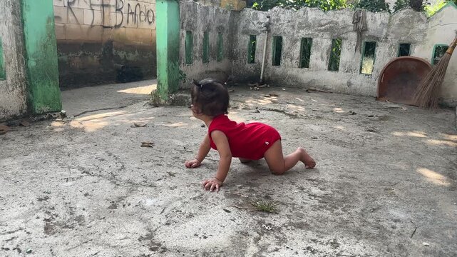 Baby in Red Romper Crawling on Concrete Outdoors