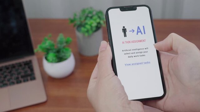 Hands hold a smartphone showing an AI task assignment screen where artificial intelligence selects and assigns daily work tasks.