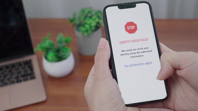 Identity check failed stop notice appears on an AI information app as a person considers tapping Try verification again.
