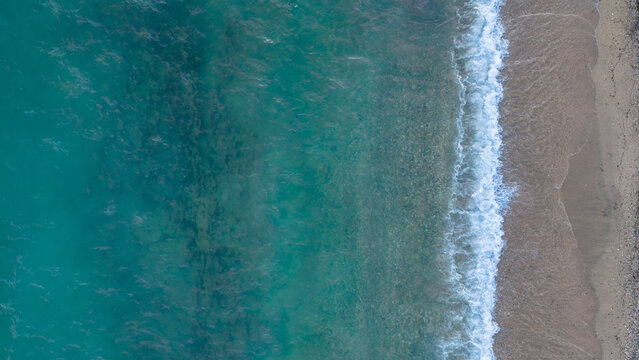 Turquoise Waves Meeting Sandy Shore Along Nea Moudania Greece