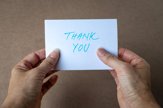 Hands holding a thank you card
