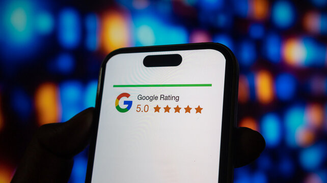 Person holding iphone 15 pro max with google rating logo and 5 star review on screen.
