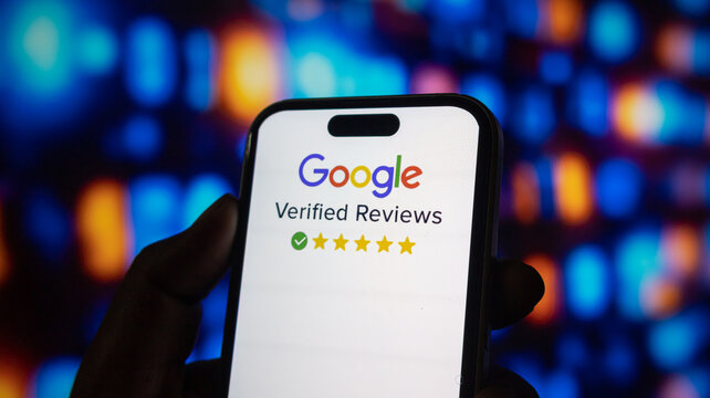 Person holding iphone 15 pro max with google verified reviews logo and 5 star rating on screen.