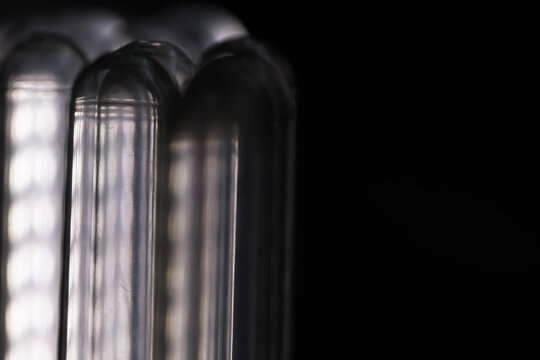 Close-Up of Energy-Efficient Fluorescent Light Tubes Against Dark Background